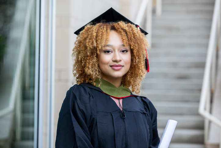 Portrait of young adult female at her college graduation