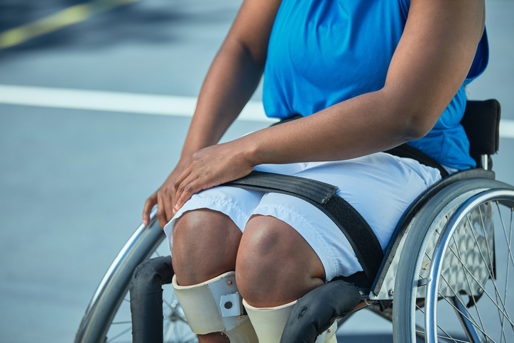 Shot of a unrecognizable female wheelchair basketball player on an outdoor court