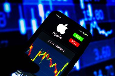 In this photo illustration the stock trading graph of Apple...
