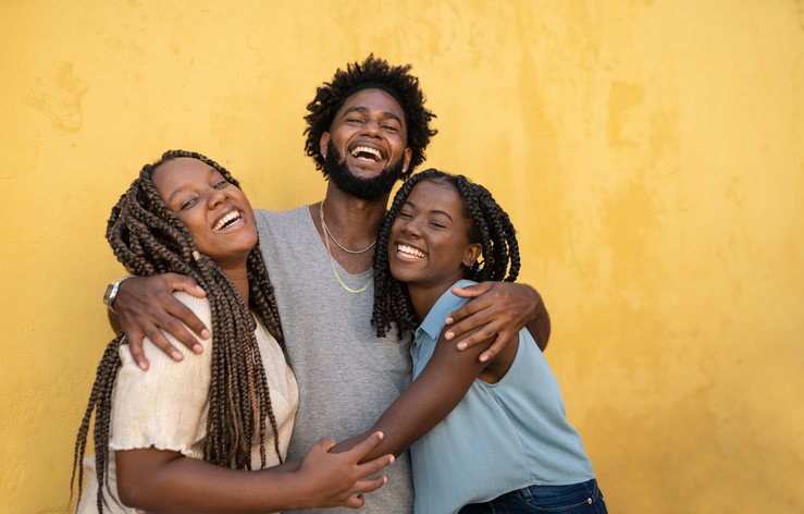 Hugging afro people yellow background