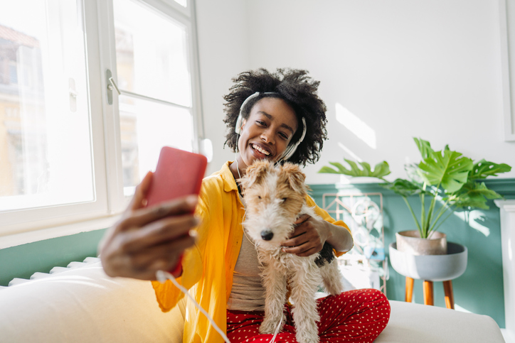 Young woman and her dog on a video call
