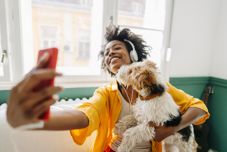 Young woman and her dog on a video call