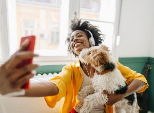 Young woman and her dog on a video call