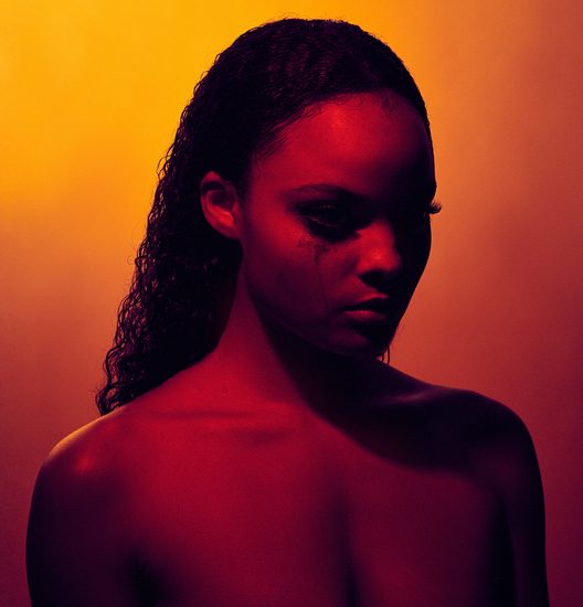 Young Woman Against Orange Background