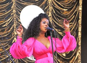 Kelis sings in a hot pink dress at Glastonbury Festival.