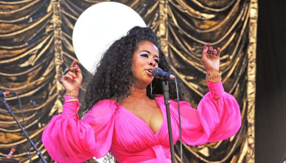 Kelis sings in a hot pink dress at Glastonbury Festival.