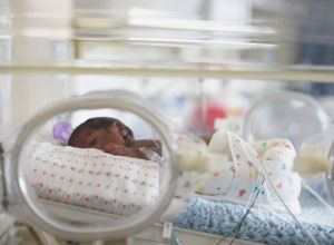 African American baby in hospital incubator