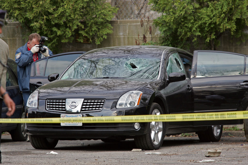 (4/20/05-Dorchester, MA) Police Crime Scene photographer photographs at the scene of a stabbing behind 100 Itasca Street, 4/20/05. (042005stabbingsc02-staff photo by stuart cahill, saved in thurs)