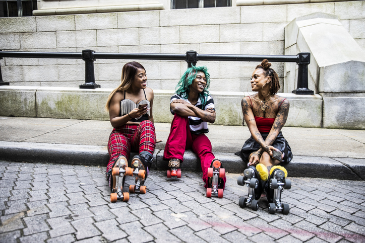 Female rollerskaters hanging out in urban area