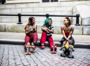 Female rollerskaters hanging out in urban area