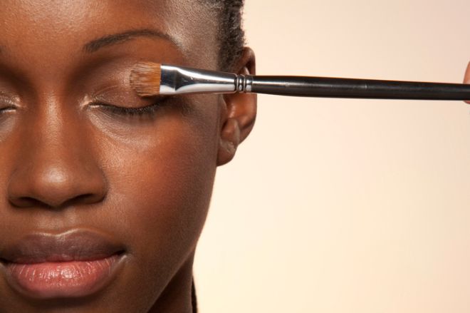 Woman with eye make up brush on eye