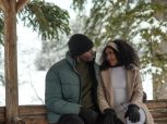 Attractive and stylish couple share romantic moment in gazebo in winter setting