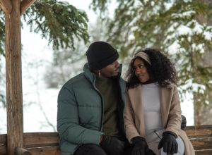 Attractive and stylish couple share romantic moment in gazebo in winter setting