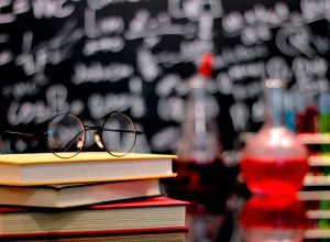 Laboratory Research. Scientific Glassware and blackboard of chemistry teaching with glasses