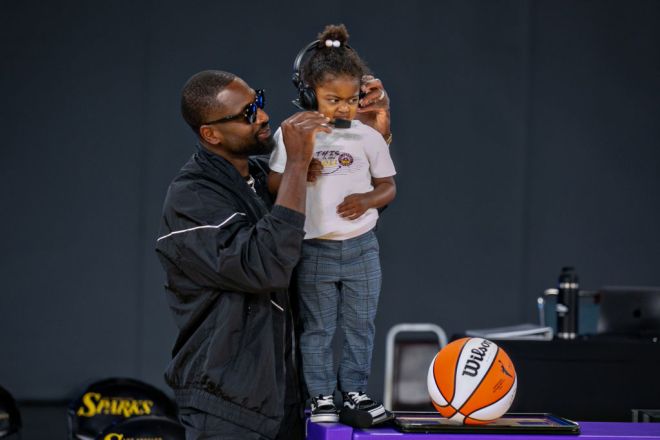 Lebron James and Dwyane Wade attend a Los Angeles Sparks WNBA game