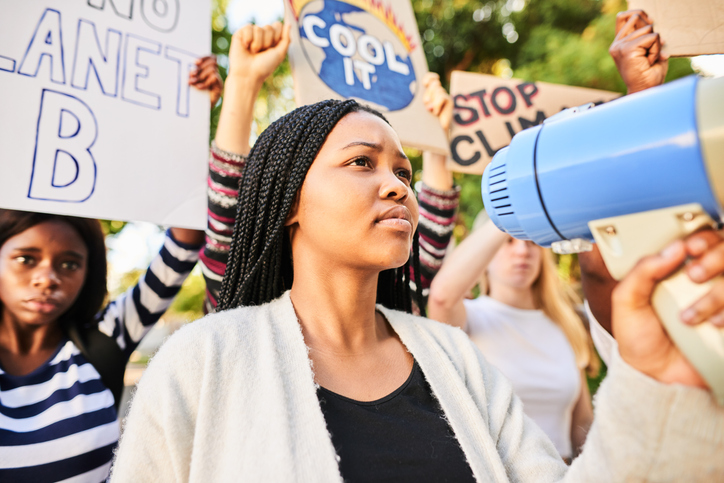 Teen girl using a megaphone during a climate change protest