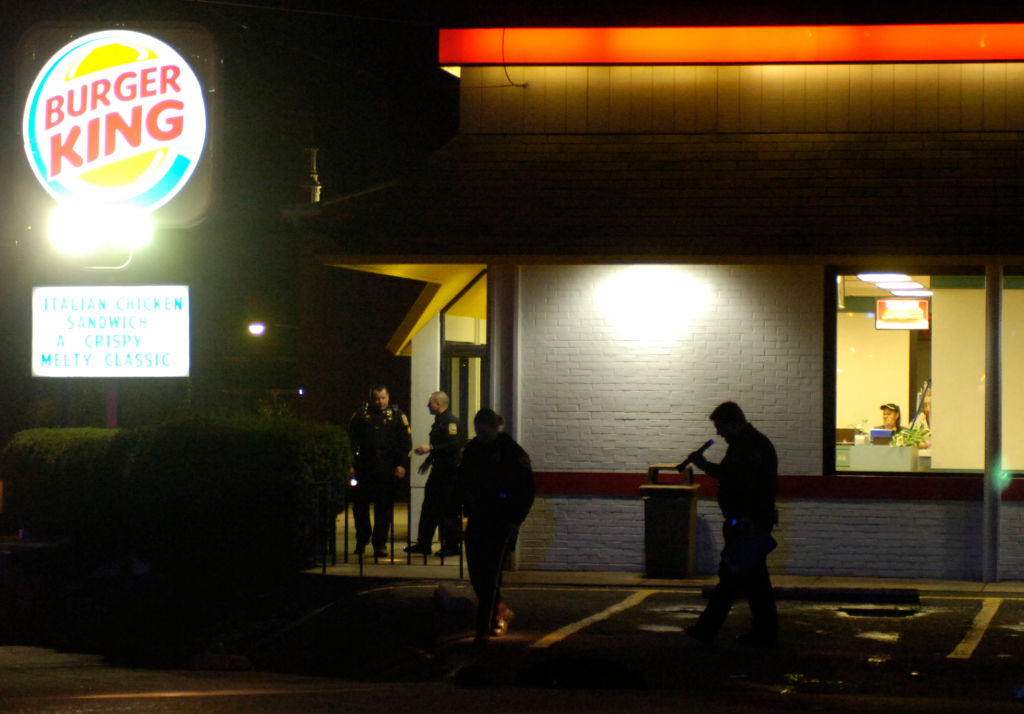 ** POLICE ARE MEANT TO BE SILHOUETTES, THANKS!**Photo by Lauren A. LittleNovember 27, 2006Police search the parking lot outside the 5th Street Burger King after a shooting Monday night.