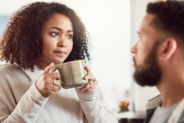 Shot of a young couple drinking coffee in their kitchen at home