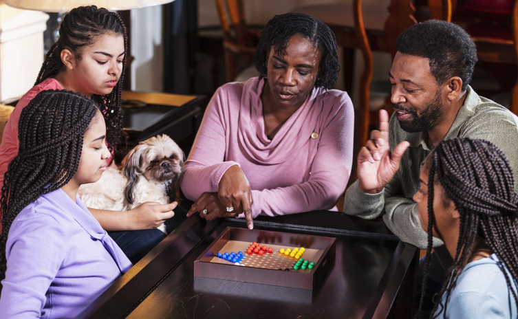 African-American family at home playing chinese checkers