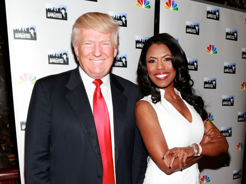 Omarosa stands besides Trump and smiles during All-Star Celebrity Apprentice.