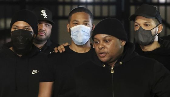 Jussie Smollett walks out of jail surrounded by bodyguards.