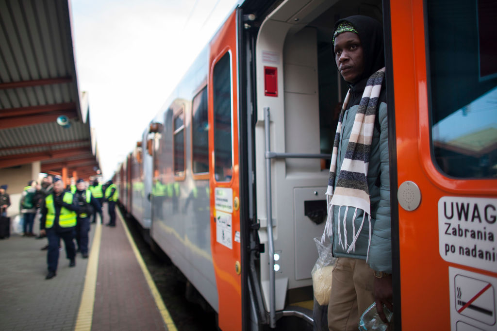 Black refugees board train from Ukraine In Poland.