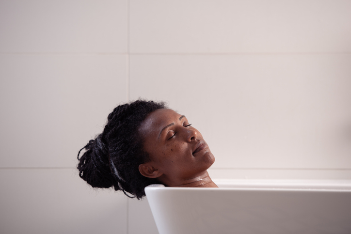 Portrait of beautiful Ethiopian woman with afro hair enjoying bathing.