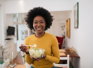 Portrait of a beautiful African American woman enjoying her food at home