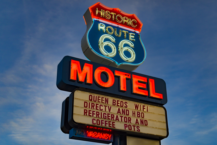 Historic Route 66 Motel neon sign glowing at sunset