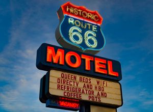 Historic Route 66 Motel neon sign glowing at sunset