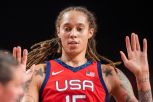 Brittney Griner throws her hands up while playing at the The Olympic Games in Tokyo 2020.