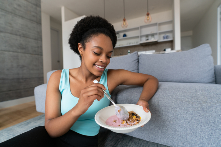 Woman eating a healthy breakfast at home