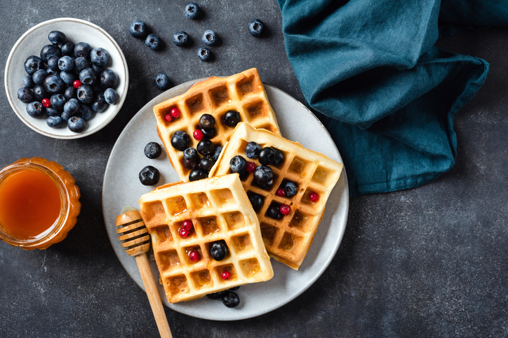 Sweet belgian waffles with blueberries and honey