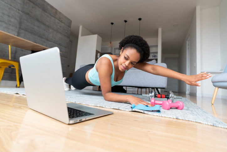 Woman training at home watching online workout classes