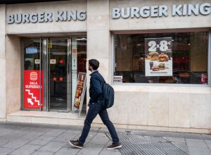A pedestrian walks past the American fast-food hamburger...