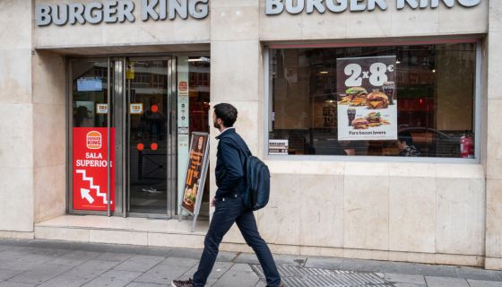 A pedestrian walks past the American fast-food hamburger...