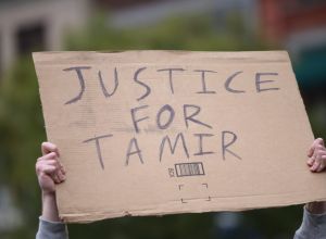 Justice for Tamir sign held aloft. Stop Mass Incarcerations...