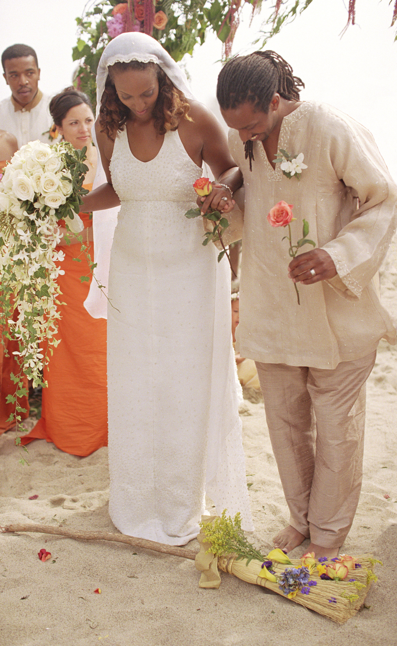 Couple jumping broom at wedding ceremony