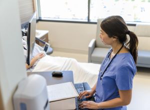 OBGYN Female doctor works quietly on computer while patient rests