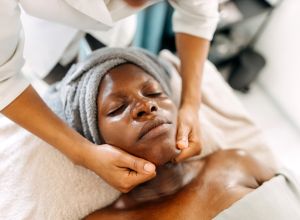 Woman enjoys a facial massage as one of weird spa treatments