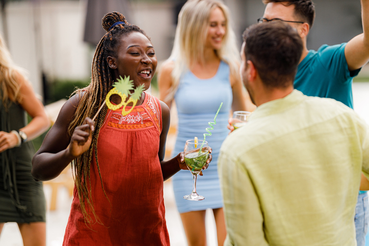 Happy black woman enjoying in summer party with her friends.