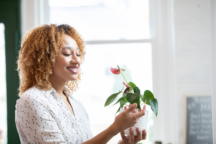 Woman realizing benefits of indoor plants