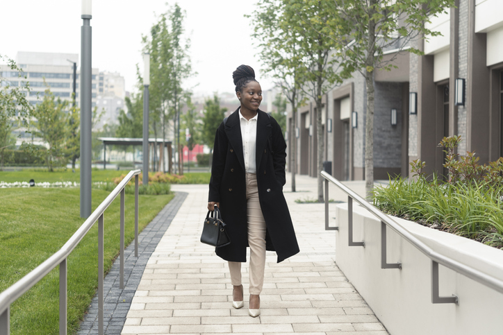Stylish African American walking to work in winter fashion 