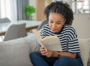 Woman relaxing and reading Black literature