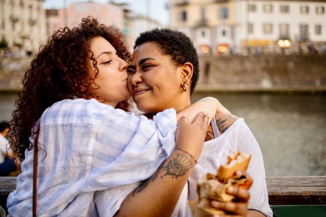 Multiracial girl kisses her best friend