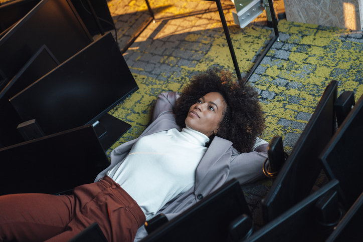 Businesswoman resting on floor at work place