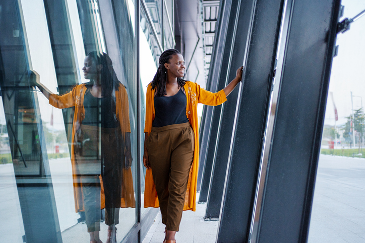 Portrait of a black business woman walking near the office building