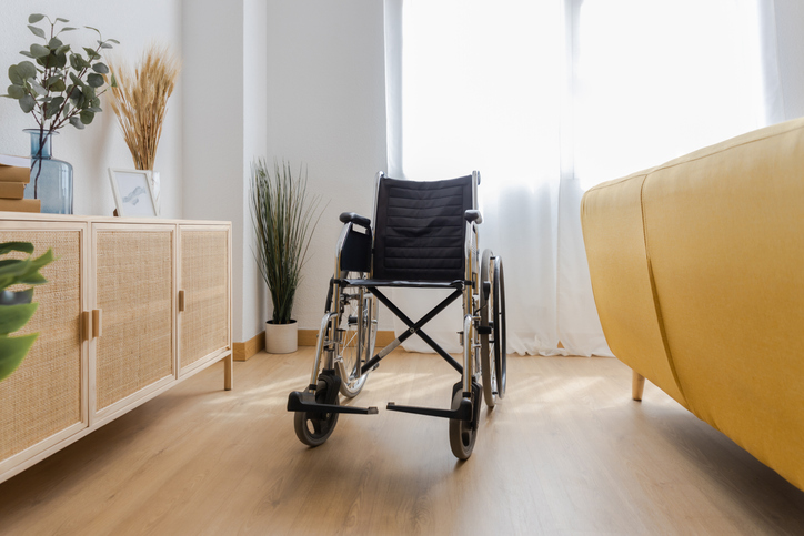 An empty wheelchair in the living room of a house