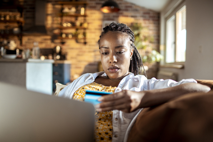 Young African woman struggling with emotional spending