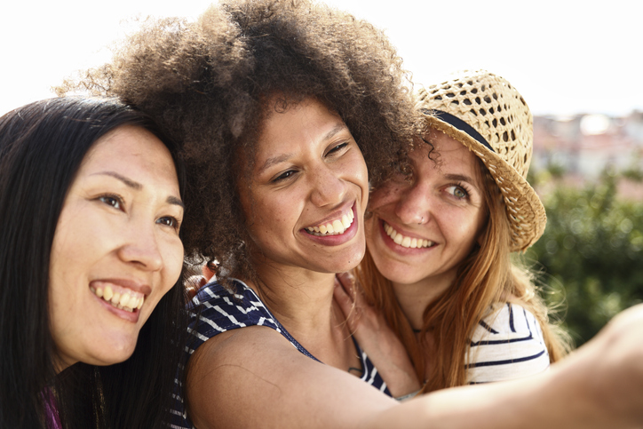 Mixed race female friends making a selfie